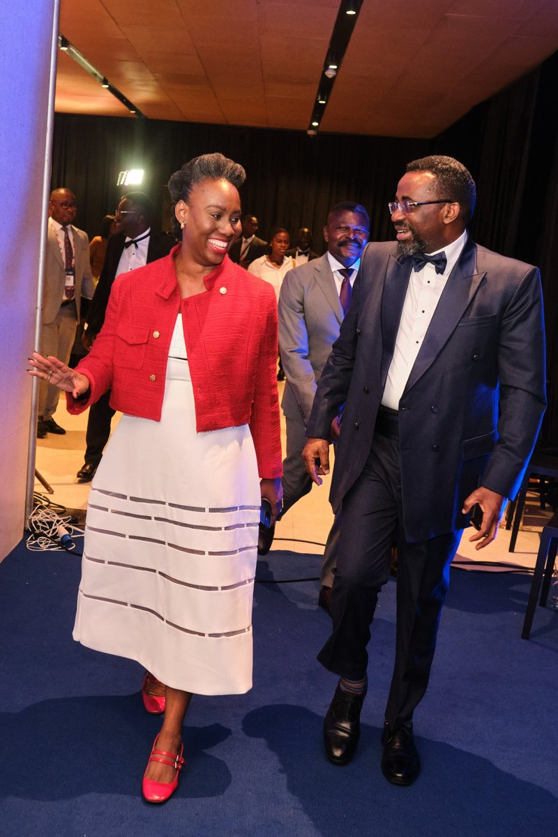 Ethel Cofie walking with the Governor of the Bank of Ghana at an event