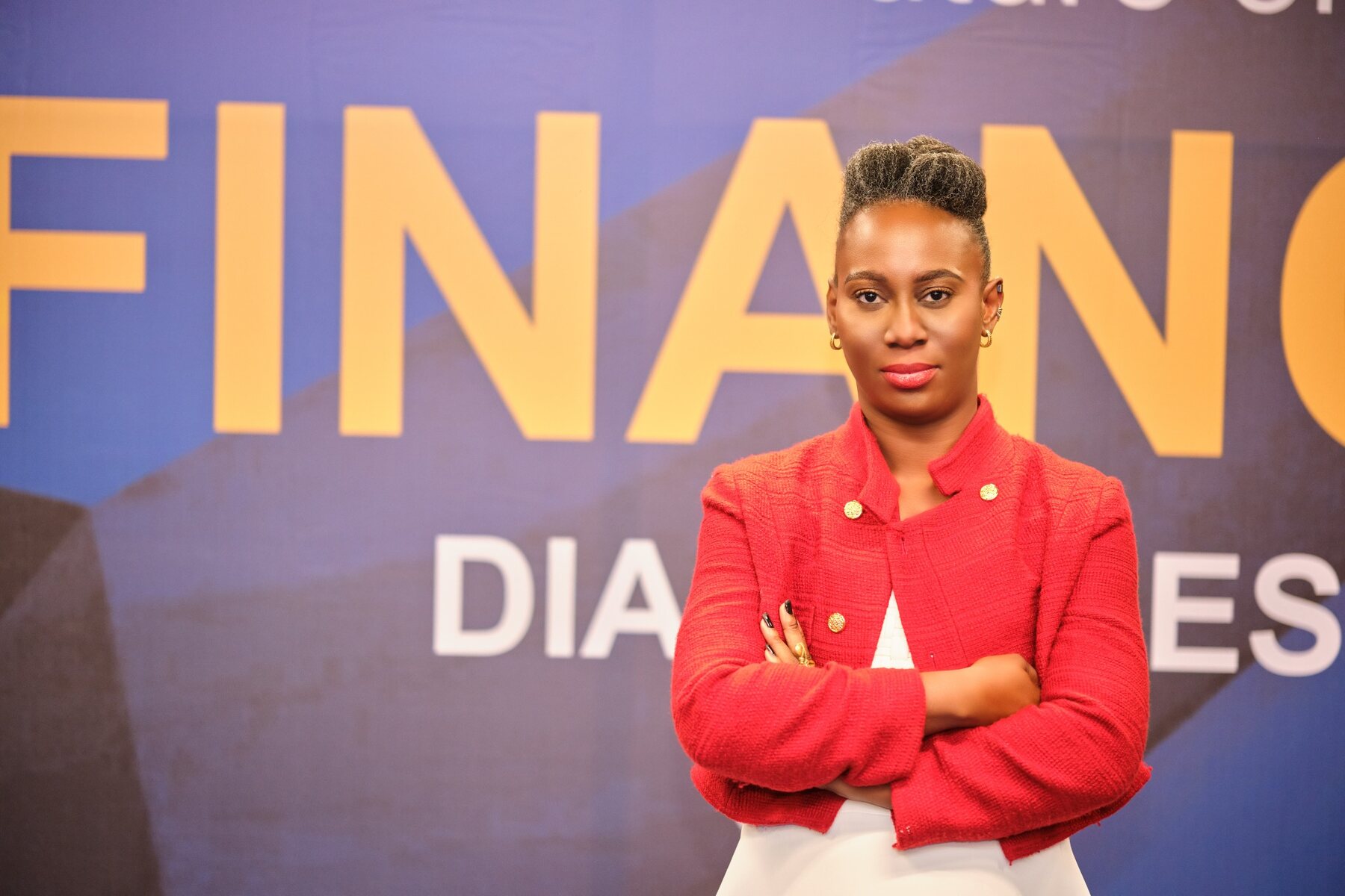 Ethel Cofie standing in front of Future of Finance Dialogues branding